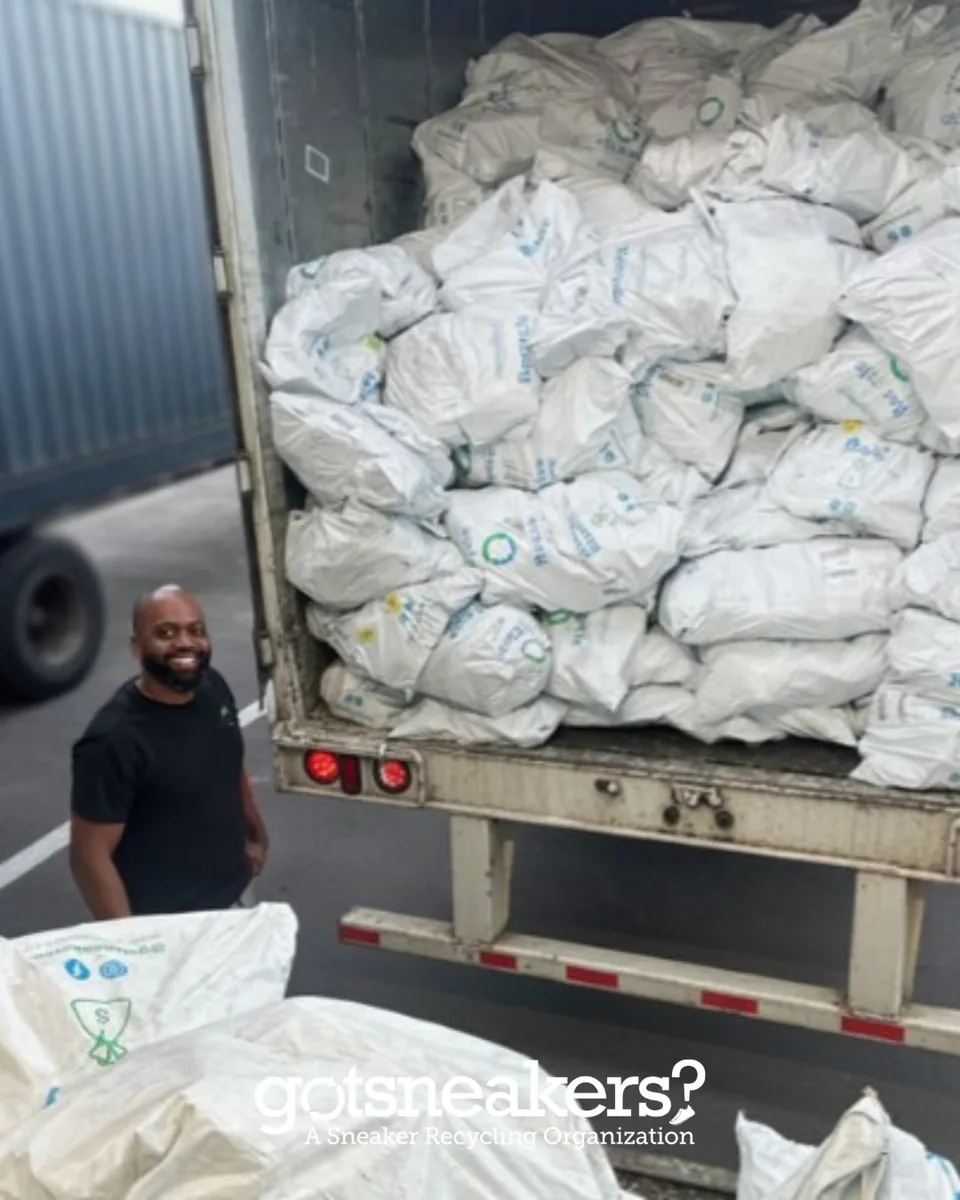 A GotSneakers team member loading a truck full of collection bags